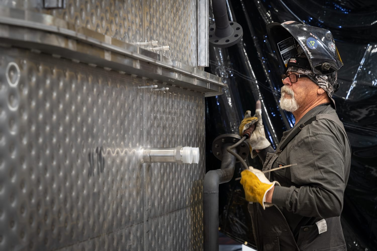 A worker welding an Antora thermal battery.